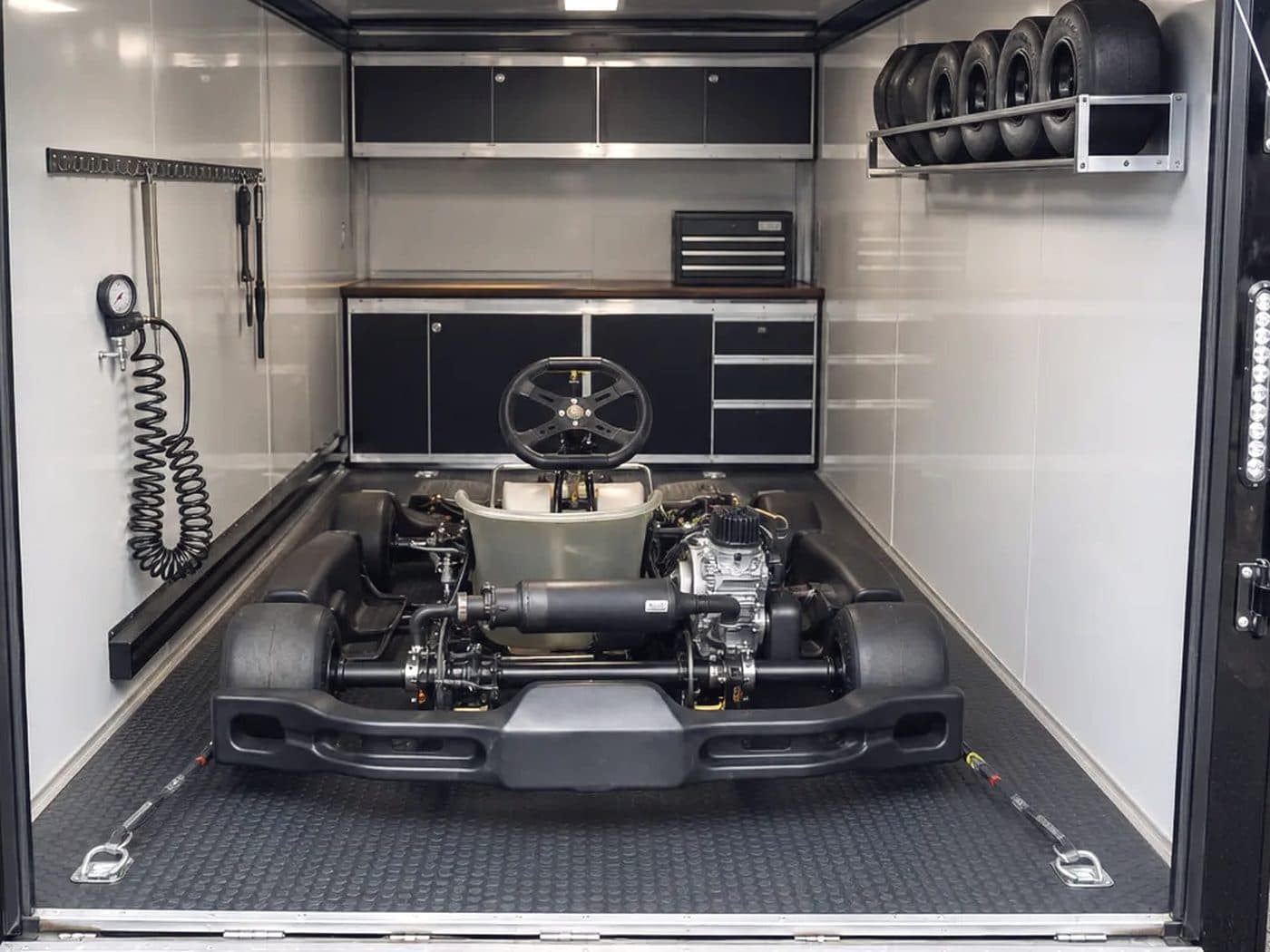 Inside a BM-24 — Kart strapped, tires racked, bench forward